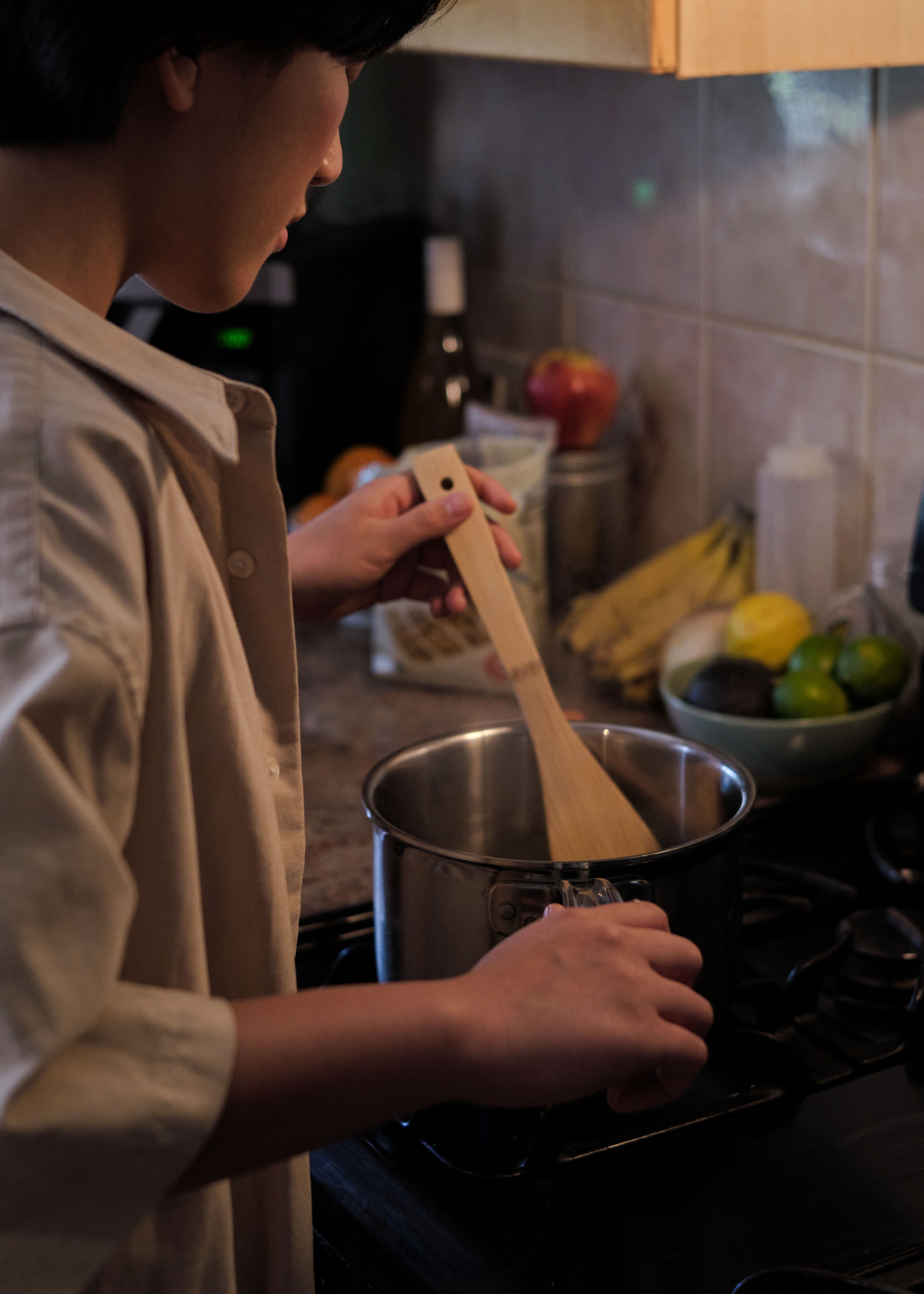 A non-binary trans man boiling pasta